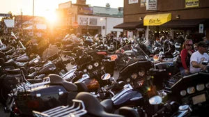 large number of motorcycle parked outside of a bar